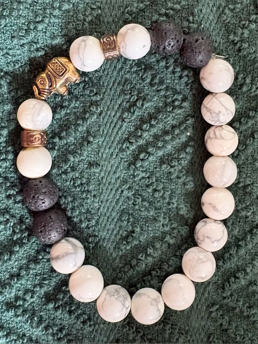 Howlite and Black Lava Bead Stretch Bracelet with Gold Elephant Accent